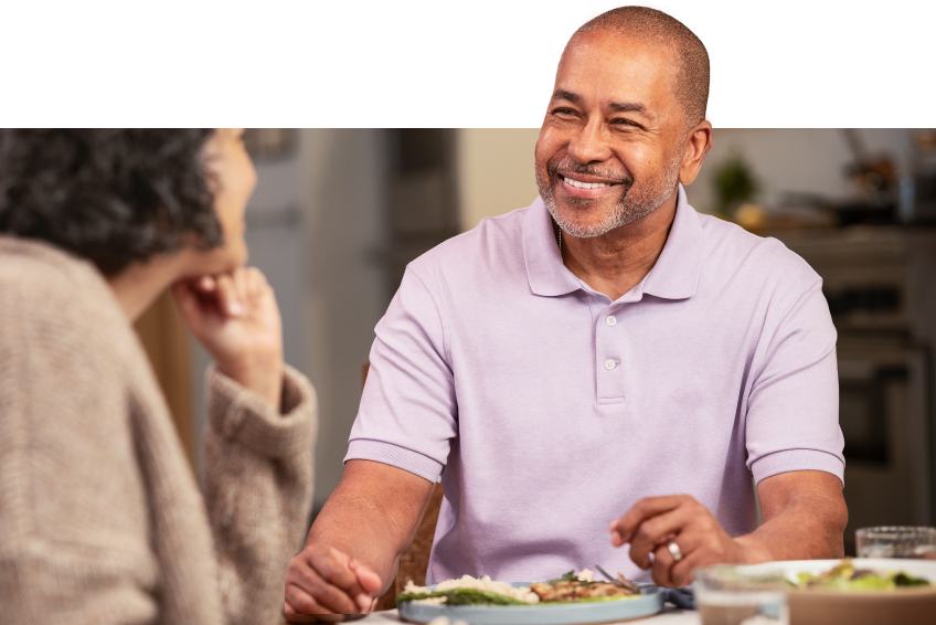 man smiling at dinner table