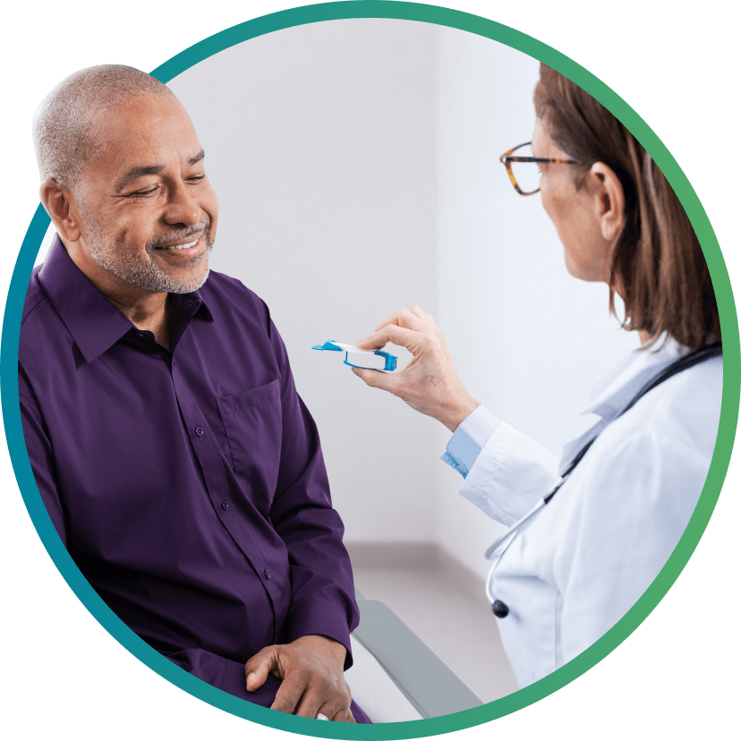 doctor showing TYVASO DPI inhaler to patient